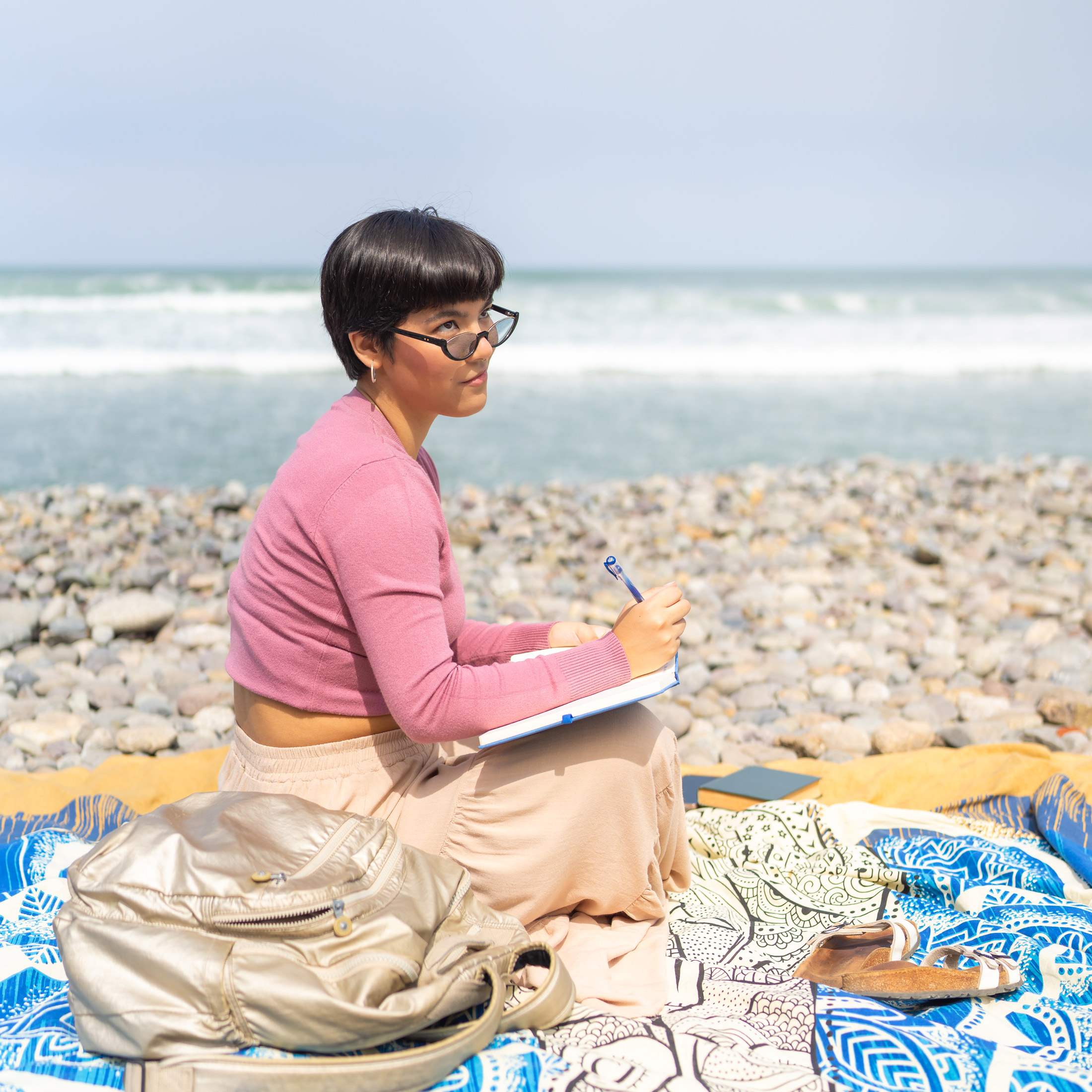 woman in Brean beach writing a travel journal