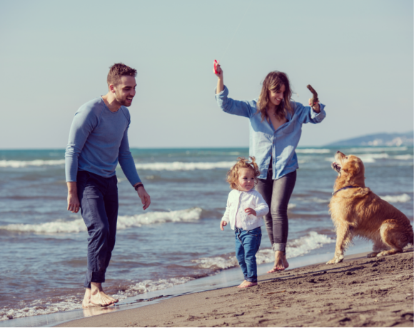 Family with dog on the beach